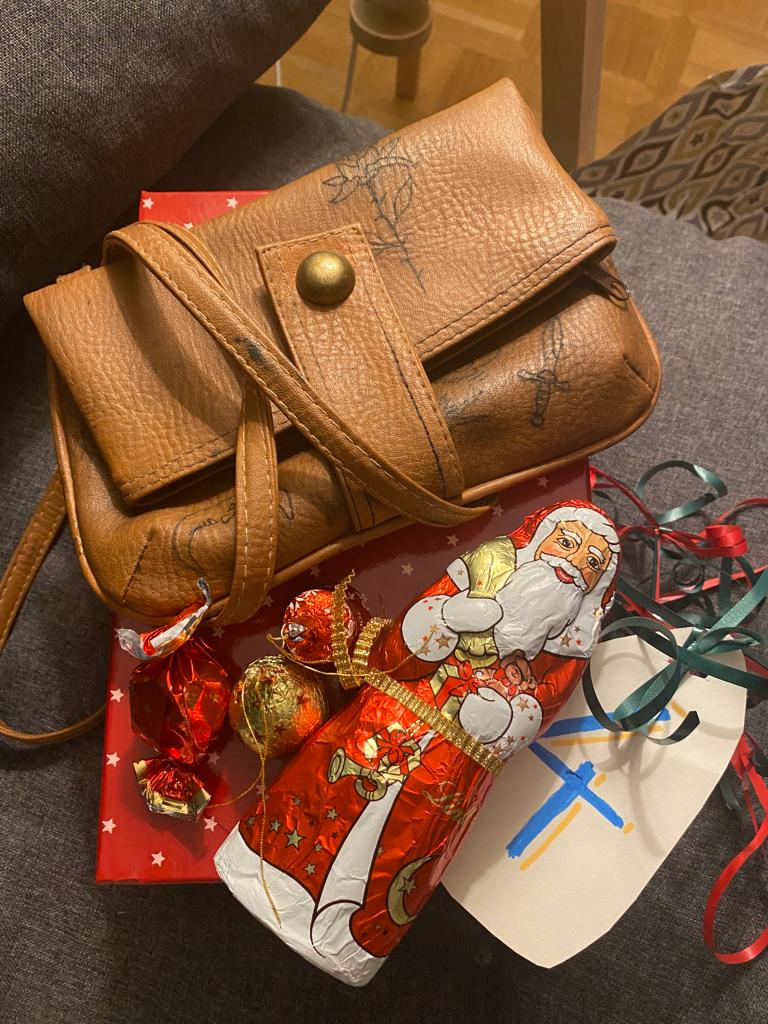 eine tätowierte Ledertasche und ein Schoko-Weihnachtsmann